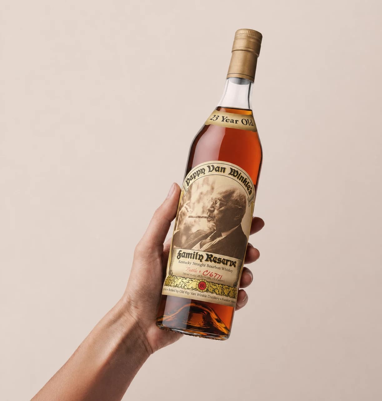 A bottle of Pappy Van Winkle's Family Reserve 23 Year, bottle number C16771, held up in hand